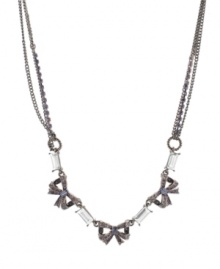 Fashionable and feminine. A trio of bows are adorned with glittering crystal accents on this stunning necklace from Betsey Johnson. Crafted in hematite tone mixed metal, it features textured ring details and chain embellishment. Approximate length: 16 inches + 3-inch extender. Fashionable and feminine. A trio of bows are adorned with glittering crystal accents on this stunning necklace from Betsey Johnson. Crafted in hematite tone mixed metal, it features textured ring details and chain embellishment. Approximate length: 16 inches + 3-inch extender.