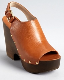 KORS Michael Kors takes a unique stance on a clog silhouette with the Scotia sandals, a luxe style in rich, tanned leather and a trend-right cutout wedge. KORS Michael Kors takes a unique stance on a clog silhouette with the Scotia sandals, a luxe style in rich, tanned leather and a trend-right cutout wedge.