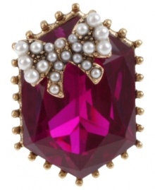 Up your glam factor with Betsey Johnson's stretch ring. Showcases a fuchsia-colored gem with a glass pearl bow accent. Crafted in antiqued gold tone mixed metal. Ring stretches to finger. Up your glam factor with Betsey Johnson's stretch ring. Showcases a fuchsia-colored gem with a glass pearl bow accent. Crafted in antiqued gold tone mixed metal. Ring stretches to finger.