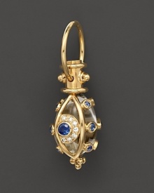 An 18K yellow gold evil eye amulet, set with diamonds and sapphires, frames a crystal. By Temple St. Clair. An 18K yellow gold evil eye amulet, set with diamonds and sapphires, frames a crystal. By Temple St. Clair.