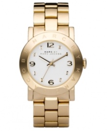 Go for all that glitters. This ultra-cool Marc by Marc Jacobs watch features a goldtone ion-plated stainless steel bracelet and round case. Logo etched at bezel. White dial with logo, goldtone numerals and crystal accents at markers. Quartz movement. Water resistant to 30 meters. Two-year limited warranty. Go for all that glitters. This ultra-cool Marc by Marc Jacobs watch features a goldtone ion-plated stainless steel bracelet and round case. Logo etched at bezel. White dial with logo, goldtone numerals and crystal accents at markers. Quartz movement. Water resistant to 30 meters. Two-year limited warranty.