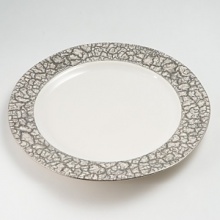 Michael Wainwright has created elegant porcelain since 1991. Each piece is made of porcelain and fired in a kiln at least three times. First, the rims are cut by hand, so that no two pieces are exactly alike. Second, the wares are glazed by hand and fired to nearly 2200 degrees F., 22-karat gold or platinum is hand painted on each piece and fired in a kiln one more time, resulting in a finish that is dishwasher-safe. Michael Wainwright has created elegant porcelain since 1991. Each piece is made of porcelain and fired in a kiln at least three times. First, the rims are cut by hand, so that no two pieces are exactly alike. Second, the wares are glazed by hand and fired to nearly 2200 degrees F., 22-karat gold or platinum is hand painted on each piece and fired in a kiln one more time, resulting in a finish that is dishwasher-safe.