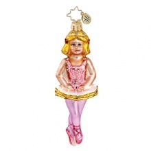 A miniature ballerina shines in a pink tutu and pointe shoes. A miniature ballerina shines in a pink tutu and pointe shoes.