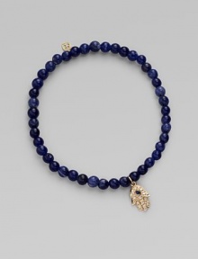 The open hand or hamsa, a symbol of protection to many cultures, is depicted in diamonds set in 14k yellow gold with a sapphire center, and hangs on a strand of deeply hued sodalite beads. Diamonds, 0.04 tcw Sapphire Sodalite 14k yellow gold Diameter, about 2 Charm length, about ½ Stretch cord Imported The open hand or hamsa, a symbol of protection to many cultures, is depicted in diamonds set in 14k yellow gold with a sapphire center, and hangs on a strand of deeply hued sodalite beads. Diamonds, 0.04 tcw Sapphire Sodalite 14k yellow gold Diameter, about 2 Charm length, about ½ Stretch cord Imported