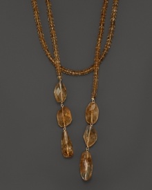 Citrine roundels and nuggets combine with 14K gold to create an elegant lariat necklace. Citrine roundels and nuggets combine with 14K gold to create an elegant lariat necklace.