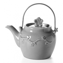 Crafted by hand of weighty ceramic with a glossy glaze, the Laces Teapot from Mateus showcases subtle variations in color that highlight a dimensional flowering branch motif. Crafted by hand of weighty ceramic with a glossy glaze, the Laces Teapot from Mateus showcases subtle variations in color that highlight a dimensional flowering branch motif.