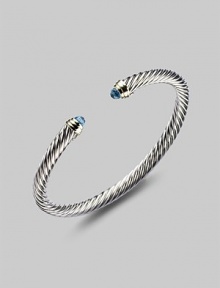 From the Color Classics Collection. A graceful sterling silver cable, capped with faceted blue topaz domes and accents of 14k gold. Blue topaz Sterling silver and 14k yellow gold Cable, 5mm Diameter, about 2¼ Imported From the Color Classics Collection. A graceful sterling silver cable, capped with faceted blue topaz domes and accents of 14k gold. Blue topaz Sterling silver and 14k yellow gold Cable, 5mm Diameter, about 2¼ Imported