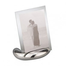 Accommodating either a vertical or horizontal photo, this rectangular photo frame consists of an oval base made of Nambé alloy and two sheets of glass to enclose a photo. The Nambé alloy base is solid and stable. Designed by Neil Cohen. Accommodating either a vertical or horizontal photo, this rectangular photo frame consists of an oval base made of Nambé alloy and two sheets of glass to enclose a photo. The Nambé alloy base is solid and stable. Designed by Neil Cohen.