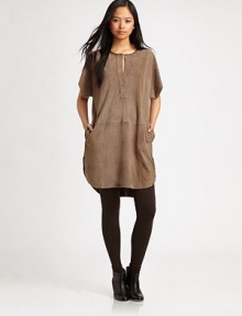 Tribal-chic tunic of velvety goat suede has dropped shoulders, short dolman sleeves and slash pockets. Crewneck with button closureDropped shouldersShort dolman sleevesSlash pocketsLonger length hits below the hipsGoat suedeDry clean with leather specialistImportedModel shown is 5'10 (177cm) wearing US size Small. Tribal-chic tunic of velvety goat suede has dropped shoulders, short dolman sleeves and slash pockets. Crewneck with button closureDropped shouldersShort dolman sleevesSlash pocketsLonger length hits below the hipsGoat suedeDry clean with leather specialistImportedModel shown is 5'10 (177cm) wearing US size Small.