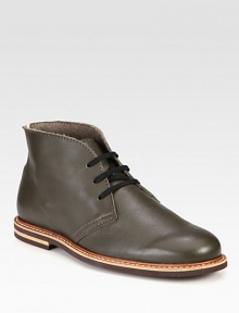 Leather lace-up chukka with contrast piping and stitching along the sole and a durable rubber sole for added support.Leather upperLeather liningPadded insoleRubber soleImported Leather lace-up chukka with contrast piping and stitching along the sole and a durable rubber sole for added support.Leather upperLeather liningPadded insoleRubber soleImported