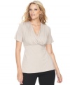 An essential component for any wardrobe, INC's classic plus size surplice top features flattering ruched sides for a feminine, soft look.