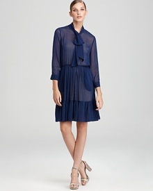 One part polished, two parts playful, this DKNY dress flaunts a flowing, sheer silhouette interrupted by a delicately ruffled hemline. One part polished, two parts playful, this DKNY dress flaunts a flowing, sheer silhouette interrupted by a delicately ruffled hemline.