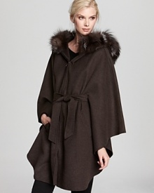 Wrap up against the chill with this sumptuous Dawn Levy cape finished with a Silver fox fur trimmed hood. Wrap up against the chill with this sumptuous Dawn Levy cape finished with a Silver fox fur trimmed hood.