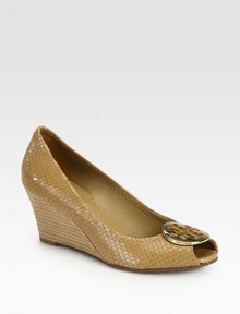 Walk confidently wearing this textured snake-print leather design with a stacked wedge, goldtone medallion and classic peep toe. Stacked heel, 2½ (65mm)Snake-print leather upperPeep toeLeather liningRubber solePadded insoleImported Walk confidently wearing this textured snake-print leather design with a stacked wedge, goldtone medallion and classic peep toe. Stacked heel, 2½ (65mm)Snake-print leather upperPeep toeLeather liningRubber solePadded insoleImported