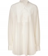 Stylish top in pure, off white silk - Soft, lightweight material drapes beautifully - Classic tunic silhouette is feminine and flattering - Small, stand-up collar and bib detail at chest - Hem hangs slightly longer in the back - Polished and truly versatile, works for day or evening - Dress up with a leather pencil skirt and ankle booties or go for a more casual look with skinny denim and ballet flats