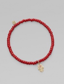 The hamsa, a traditional protective amulet, is encrusted with diamonds and accented with one ruby as it hangs from a stretchy strand of richly colored coral beads. Diamonds, 0.05 tcw Coral 14k yellow gold Diameter, about 2 (unstretched) Charm length, about ½ Imported The hamsa, a traditional protective amulet, is encrusted with diamonds and accented with one ruby as it hangs from a stretchy strand of richly colored coral beads. Diamonds, 0.05 tcw Coral 14k yellow gold Diameter, about 2 (unstretched) Charm length, about ½ Imported