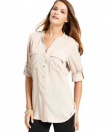 Calvin Klein's blouse features a feminine fit and buttoned roll tabs at the sleeves and sides of the hem. Calvin Klein's blouse features a feminine fit and buttoned roll tabs at the sleeves and sides of the hem.