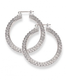 Often casually chic in nature, traditional hoop earrings get a glamorous upgrade courtesy of Swarovski. Embellished with dazzling crystals throughout, they're set in silver tone mixed metal. Approximate diameter: 1-9/16 inches. Often casually chic in nature, traditional hoop earrings get a glamorous upgrade courtesy of Swarovski. Embellished with dazzling crystals throughout, they're set in silver tone mixed metal. Approximate diameter: 1-9/16 inches.
