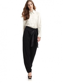 THE LOOKShirt collarFront button placketLong button cuff sleeves with pleated detailsPleated bib yokeU-shaped hemTHE FITAbout 25 from shoulder to longest point of hemTHE MATERIAL96% cotton/4% other fibersCARE & ORIGINDry cleanMade in Italy THE LOOKShirt collarFront button placketLong button cuff sleeves with pleated detailsPleated bib yokeU-shaped hemTHE FITAbout 25 from shoulder to longest point of hemTHE MATERIAL96% cotton/4% other fibersCARE & ORIGINDry cleanMade in Italy