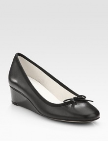 An elevated self-covered wedge silhouette of patent leather, topped with a pretty grosgrain bow. Self-covered wedge, 1½ (40mm)Leather and grosgrain upperLeather liningRubber solePadded insoleMade in France An elevated self-covered wedge silhouette of patent leather, topped with a pretty grosgrain bow. Self-covered wedge, 1½ (40mm)Leather and grosgrain upperLeather liningRubber solePadded insoleMade in France