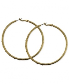 A stylish must-have. These clutchless hoop earrings from GUESS feature a diamond dust design with glass stones. Crafted in gold tone mixed metal. Approximate diameter: 2-1/2 inches. A stylish must-have. These clutchless hoop earrings from GUESS feature a diamond dust design with glass stones. Crafted in gold tone mixed metal. Approximate diameter: 2-1/2 inches.