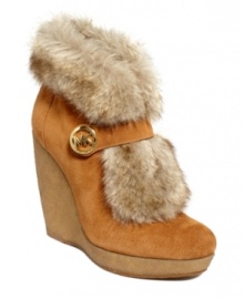 So furry and fun. MICHAEL Michael Kors' Lara platform wedge booties are decorated with a designer logo on the Mary Jane strap and a cozy and cute fluffy, faux-fur lining.