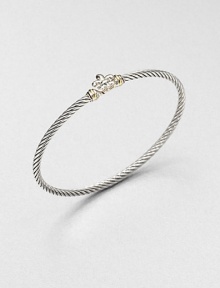 From the Cable Collectibles Collection. A graceful fleur de lis with gold accents forms the centerpiece of this classic cable bangle.Sterling silver and 18k yellow goldCable, 3mmDiameter, about 2.25Imported From the Cable Collectibles Collection. A graceful fleur de lis with gold accents forms the centerpiece of this classic cable bangle.Sterling silver and 18k yellow goldCable, 3mmDiameter, about 2.25Imported
