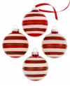 Stripes of green and white glitter on holiday-red ball ornaments tailor the tree in timeless holiday style.