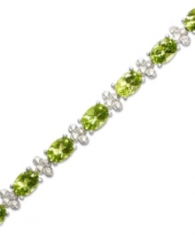 Inspired by spring. This light and airy tennis bracelet features gleaming oval-cut peridot (14 ct. t.w.) alongside diamond-accented links. Crafted in sterling silver. Approximate length: 7 inches. Inspired by spring. This light and airy tennis bracelet features gleaming oval-cut peridot (14 ct. t.w.) alongside diamond-accented links. Crafted in sterling silver. Approximate length: 7 inches.
