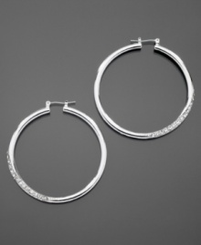 GUESS dresses up classic hoop earrings with sparkling pave crystal details. Crafted in silvertone mixed metal. Approximate diameter: 1-1/2 inches. GUESS dresses up classic hoop earrings with sparkling pave crystal details. Crafted in silvertone mixed metal. Approximate diameter: 1-1/2 inches.