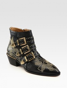 Smooth leather design with goldtone stud detail and a trio of buckle straps. Stacked heel, 2 (50mm)Studded leather upperSide zipperLeather lining and solePadded insoleMade in ItalyOUR FIT MODEL RECOMMENDS ordering true size. Smooth leather design with goldtone stud detail and a trio of buckle straps. Stacked heel, 2 (50mm)Studded leather upperSide zipperLeather lining and solePadded insoleMade in ItalyOUR FIT MODEL RECOMMENDS ordering true size.