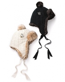 Rugged style meets girlish flair in this faux fur trapper with pom-pon ties and a cluster of sparking rhinestones. Rugged style meets girlish flair in this faux fur trapper with pom-pon ties and a cluster of sparking rhinestones.