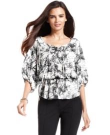 Alfani's peasant top is sophisticated with a brushstroke print and pleated placket. Alfani's peasant top is sophisticated with a brushstroke print and pleated placket.