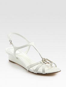Strappy patent leather wedge with an adjustable t-strap and silvertone CD embellishment. Self-covered wedge, 1½ (40mm)Patent leather upperLeather liningBuffed leather solePadded insoleMade in ItalyOUR FIT MODEL RECOMMENDS ordering one half size up as this style runs small. Strappy patent leather wedge with an adjustable t-strap and silvertone CD embellishment. Self-covered wedge, 1½ (40mm)Patent leather upperLeather liningBuffed leather solePadded insoleMade in ItalyOUR FIT MODEL RECOMMENDS ordering one half size up as this style runs small.