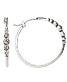 Understated and unique. With their sparkling front-facing crystal accents, Fossil's hoop earrings convey just the right amount of glitz and glamour. Crafted in silver tone mixed metal, they'll look equally chic for day or evening. Approximate diameter: 1-1/10 inches. Understated and unique. With their sparkling front-facing crystal accents, Fossil's hoop earrings convey just the right amount of glitz and glamour. Crafted in silver tone mixed metal, they'll look equally chic for day or evening. Approximate diameter: 1-1/10 inches.