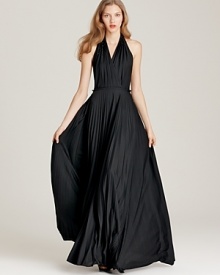 Evoke '70s-era glamour in this intricately pleated Halston Heritage halter dress, complete with shimmering tonal beads at the shoulders for extra glamour. Evoke '70s-era glamour in this intricately pleated Halston Heritage halter dress, complete with shimmering tonal beads at the shoulders for extra glamour.