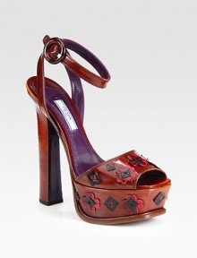 A flower appliqué defines this platform leather silhouette with an adjustable ankle strap. Self-covered heel, 6 (150mm)Covered platform, 1¾ (45mm)Compares to a 4¼ heel (110mm)Leather upperAdjustable ankle strapLeather liningLeather and rubber solePadded insoleMade in Italy A flower appliqué defines this platform leather silhouette with an adjustable ankle strap. Self-covered heel, 6 (150mm)Covered platform, 1¾ (45mm)Compares to a 4¼ heel (110mm)Leather upperAdjustable ankle strapLeather liningLeather and rubber solePadded insoleMade in Italy