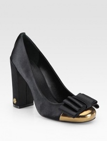 Shimmering satin design with a self-covered bow, metallic leather toecap and goldtone designer emblem at the heel. Self-covered heel, 4 (100mm)Satin and metallic leather upperLeather liningMetallic leather solePadded insoleImportedOUR FIT MODEL RECOMMENDS ordering one half size up as this style runs small. Shimmering satin design with a self-covered bow, metallic leather toecap and goldtone designer emblem at the heel. Self-covered heel, 4 (100mm)Satin and metallic leather upperLeather liningMetallic leather solePadded insoleImportedOUR FIT MODEL RECOMMENDS ordering one half size up as this style runs small.