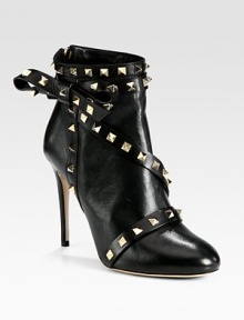 Balance masculine and feminine wearing this on-trend leather ankle boot, topped with edgy metal studs and a dimensional side bow. Self-covered heel, 4¼ (110mm)Leather upper with metal studsBack zipLeather lining and solePadded insoleMade in Italy Balance masculine and feminine wearing this on-trend leather ankle boot, topped with edgy metal studs and a dimensional side bow. Self-covered heel, 4¼ (110mm)Leather upper with metal studsBack zipLeather lining and solePadded insoleMade in Italy