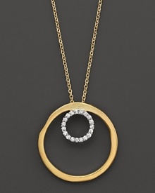 A diamond circle within a larger gold circle pendant. Designed by Meira T. A diamond circle within a larger gold circle pendant. Designed by Meira T.