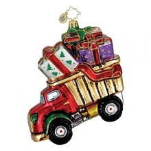 A toy dump truck hauls beautifully wrapped presents in this glass holiday ornament. A toy dump truck hauls beautifully wrapped presents in this glass holiday ornament.