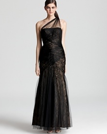Exquisitely fashioned in gauzy tulle with a delicate lace underlay, this cascading ML Monique Lhuillier one shoulder gown makes a stunning evening statement. Exquisitely fashioned in gauzy tulle with a delicate lace underlay, this cascading ML Monique Lhuillier one shoulder gown makes a stunning evening statement.