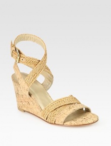 Natural cork wedge with adjustable, woven straps that make their way up the ankle. Cork-covered wedge, 3 (75mm)Straw and cork upperLeather liningBuffed leather solePadded insoleImported