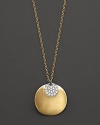 This gold concave dip medallion necklace is paired with a diamond pavé medallion. Designed by Meira T.