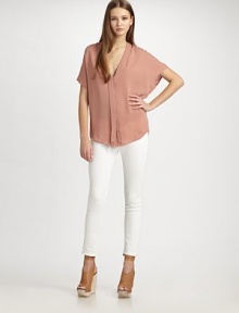 Stunning silk v-neck hits below the hips, concluding with a hidden button front and back ruching. V-neckHidden button frontShort sleevesBack ruchingLonger length hits below the hipsSilkDry cleanImportedModel shown is 5'11 (180cm) wearing US size Small. Stunning silk v-neck hits below the hips, concluding with a hidden button front and back ruching. V-neckHidden button frontShort sleevesBack ruchingLonger length hits below the hipsSilkDry cleanImportedModel shown is 5'11 (180cm) wearing US size Small.