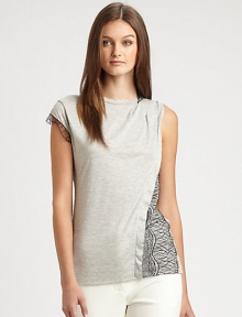 A tee with some twists, this sleeveless style is shaped with tiny pleats at one shoulder and lace trim and overlays for an edgy appeal.Round banded neckline with lace trim on one sideSleeveless on one side, cap sleeve with lace trim on the otherPleats at one shoulderAsymmetrical flange and lace overlay on one sideAbout 26 from shoulder to hemCotton/modalDry cleanImported of Italian fabricSIZE & FITModel shown is 5'10 (177cm) wearing US size Small. 