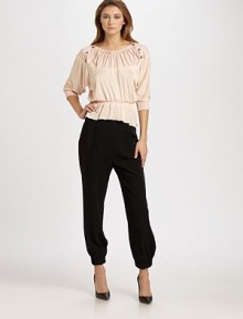 This comfortable design is embellished with a gathered neckline and chic rows of buttons at each shoulder.Gathered necklineShoulder buttonsThree-quarter dolman sleevesRib-knit cuffsBanded, elastic waistLoose peplum-style hemlineViscoseDry cleanMade in France of imported fabricModel shown is 5'11 (180cm) wearing US size 4. This comfortable design is embellished with a gathered neckline and chic rows of buttons at each shoulder.Gathered necklineShoulder buttonsThree-quarter dolman sleevesRib-knit cuffsBanded, elastic waistLoose peplum-style hemlineViscoseDry cleanMade in France of imported fabricModel shown is 5'11 (180cm) wearing US size 4.