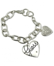 Fall in love with fashion. This lovely style from GUESS features a heart charm with jet epoxy logo and a smaller heart with shiny pave stones. Crafted in silver tone mixed metal. Approximate length: 7-1/2 inches. Fall in love with fashion. This lovely style from GUESS features a heart charm with jet epoxy logo and a smaller heart with shiny pave stones. Crafted in silver tone mixed metal. Approximate length: 7-1/2 inches.