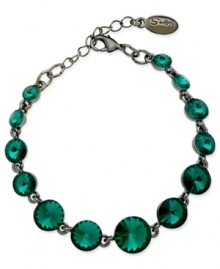 Circular chic. This bracelet from GUESS is crafted from hematite-tone mixed metal with teal glass crystal stones adding a vibrant touch. Item comes packaged in a signature GUESS Gift Box. Approximate length: 7-1/2 inches. Circular chic. This bracelet from GUESS is crafted from hematite-tone mixed metal with teal glass crystal stones adding a vibrant touch. Item comes packaged in a signature GUESS Gift Box. Approximate length: 7-1/2 inches.