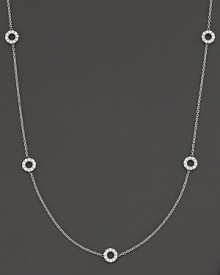 A delicate white gold chain with 5 double-sided white gold diamond circle stations. A delicate white gold chain with 5 double-sided white gold diamond circle stations.